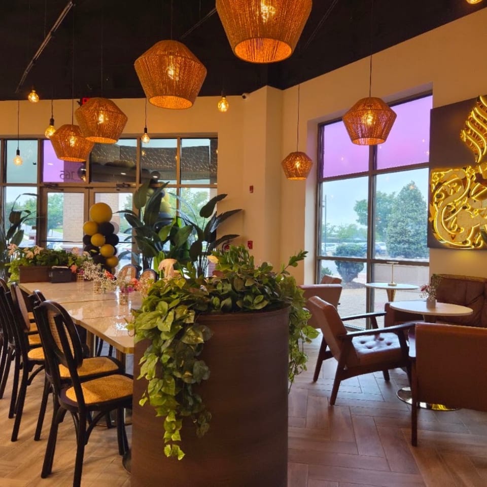 High Point seating area with plants and glowing wall art.